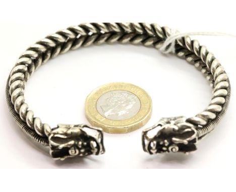White metal Tibetan silver twisted bangle with dragon head terminals. P&amp;P Group 1 (£14+VAT for the first lot and £1+VAT f