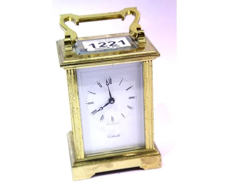 Brass carriage clock by Cottrills with key, having visible escapement. P&amp;P Group 2 (£18+VAT for the first lot and £3+VAT 