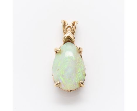 14k yellow gold pendant with filigree gallery rail set with a large pear shaped opal of white body color with flashes blue an