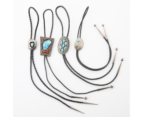 Group of four bolo ties including:One bolo tie on braided black leather cord with sterling silver placard and aglets. The pla
