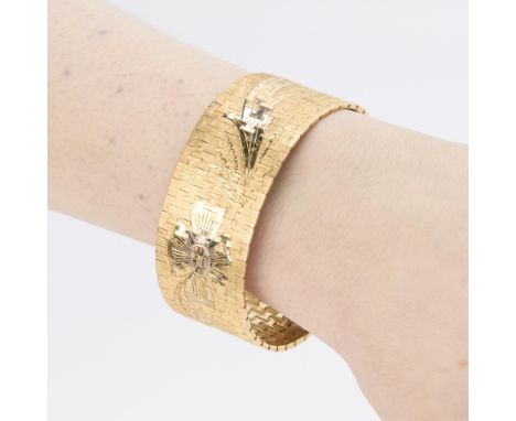18k yellow white and rose gold strap bracelet with textured yellow gold ground and floral motif with rose anf white gold acce