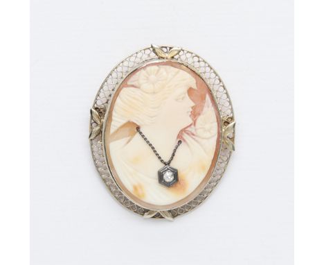 14k white gold cameo habille brooch depicting a woman in profile wearing a necklace set with a small single cut diamond. With
