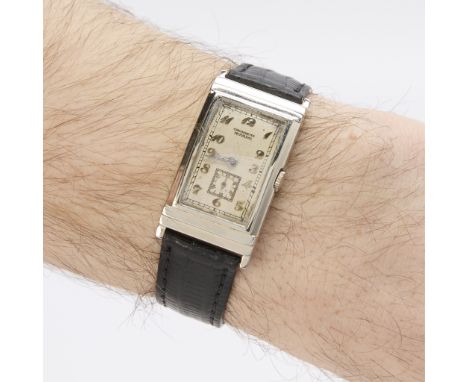 Movado curved wristwatch circa 1947. In 18k white gold case with white dial and applied white gold Arabic numerals and sub se