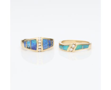 Group of two 14k yellow gold, diamond and opal rings. Including:One 14k yellow gold ring set with four blue and green opal pa