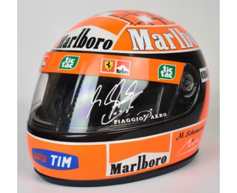 Michael Schumacher signed replica Formula 1 Ferrari helmet with Marlboro sponsorship, autographed in silver ink to visor, hei