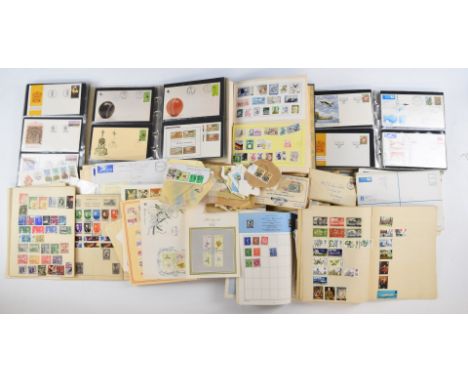 A collection of South African first day covers in two albums and loose in philatelic envelopes, and world stamps in various a