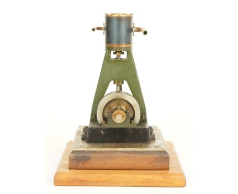 Vertical single cylinder live steam engine with solid flywheel, on wooden base, height 19cm