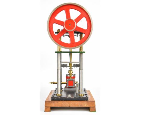 Inverted single cylinder live steam engine with turned column supports, driving a spoked flywheel, on wooden base, height 45.