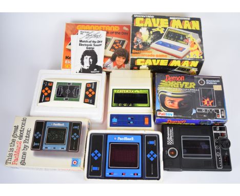 Four retro LCD digital tabletop games by Grandstand, Entex and Palitoy comprising Cave Man, Kevin Keegan's Match of the Day, 