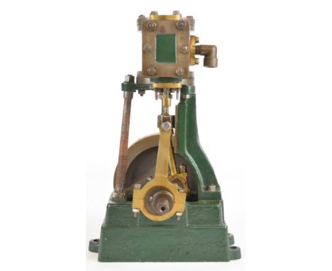 Vertical single cylinder live steam engine in the style of a small Stuart No 1, the solid flywheel having balance weight to r