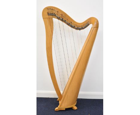 Thirty four string lever harp in beech wood with walnut inlay, height 128cm, with padded carry case.