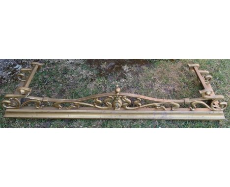 A brass fireside fencer, with Art Nouveau style scroll decoration
