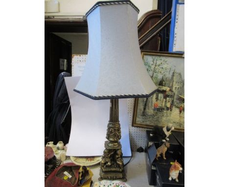 A gilt table lamp, decorated with cherubs