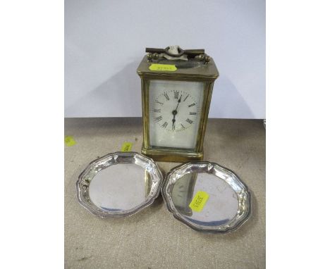A brass cased carriage clock, together with a pair of Christofle France dishes