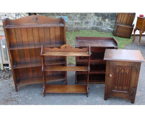 A bookcase, wall shelves, standard lamp, and two other pieces of furniture