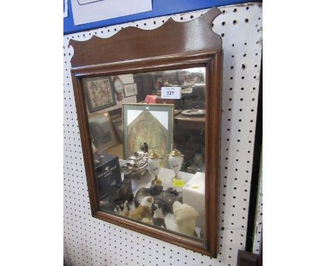 A wall mirror and a semi circular wall shelf