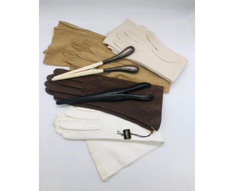 A selection of four pairs of vintage leather gloves and two glove stretchers 