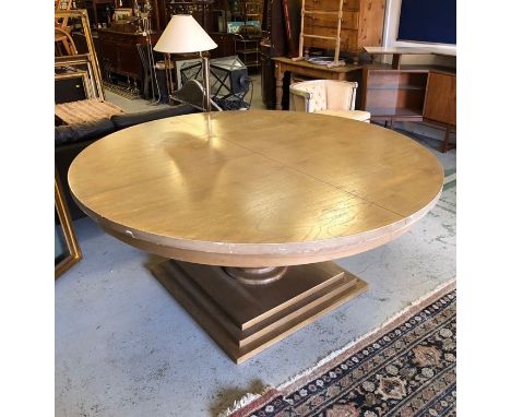 A Large round pedestal dining table on a large square base in light oak, 180 cm diameter. (marks to top)