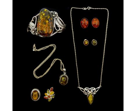 Silver amber jewellery including bangle, two pendant necklaces, two pairs of stud earring and two ringsCondition Report:Ring 