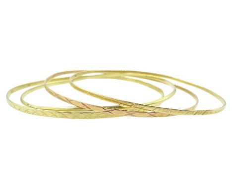 Three 14ct gold bangles and a 9ct rose gold bangleCondition Report:14ct approx 11.9gm, 9ct approx 2.45gm, all slightly bent, 