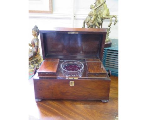 A Regency rosewood sarcophagus form tea caddy, with two lidded compartments and a later mixing bowl, on pad feet, 36 cm wide 