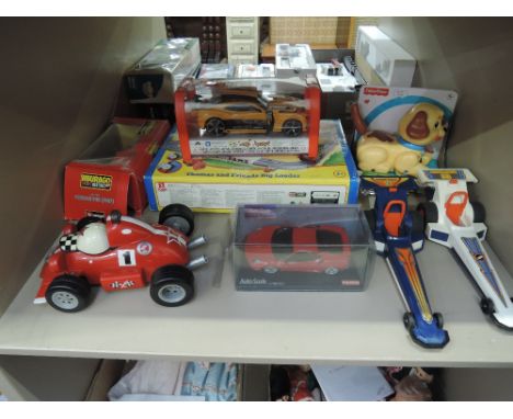 A shelf of modern toys including Burago diecast, Fisher Price dragsters and dog, Thomas the Tank Engine train set etc, most b