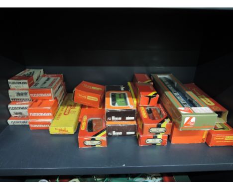 A shelf of 00 gauge and HO scale rolling stock, accessories and track including Hornby, Fleischmann, Lima etc, all boxed