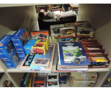 A shelf of mixed vintage Corgi and Matchbox diecast advertising and vintage vehicles, all boxed along with related magazines