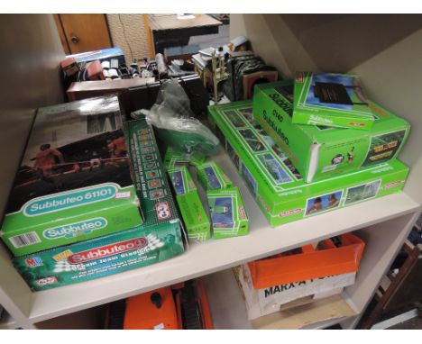 A shelf of mixed vintage Subbuteo accessories including Grandstand, boxed C140, Floodlights, boxed 61101, 1990's boxed set et