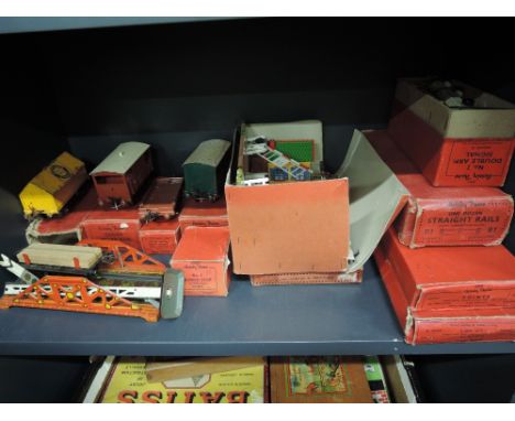 A shelf of Hornby 0 gauge wagons, accessories and track including brake van, level crossing, signals etc, most boxed