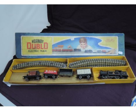 A Hornby Dublo 00 gauge three rail BR goods set comprising 0-6-2 tank engine 69567, four wagons and track in origina partl bo