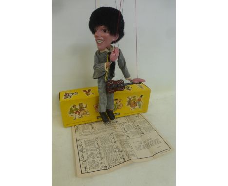 A boxed Pelham Puppet - Pop Singer no. 1, a guitarist in striped outfit based on one of the Beatles, with instructions and or