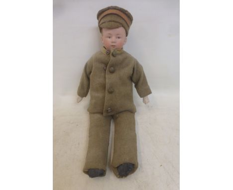 A Gebruder Heubach bisque shoulder head doll with intaglio eyes, dressed as a First World War Middlesex Regiment soldier. Bis