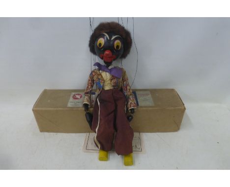 A Pelham puppet - 'Golliwog' 1953, the rare 20" version of wooden construction in a silk outfit, as sold by Harrods, in origi
