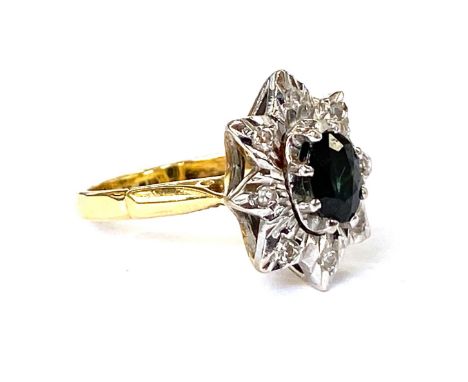 An 18ct gold star shaped ring set with a central sapphire surrounded by diamonds, size L 1/2, 6.3g 