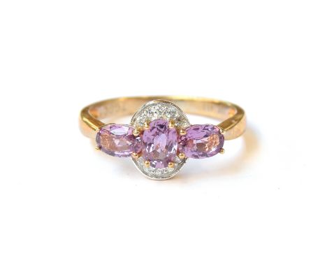 A 10ct gold ring set with purple sapphires and natural white zircons, the sapphires totalling 1.54cts, size P 1/2, 2.6g 