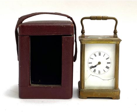 A brass carriage clock, 12cmH (glass af), in a fitted leather carry case with velvet interior 