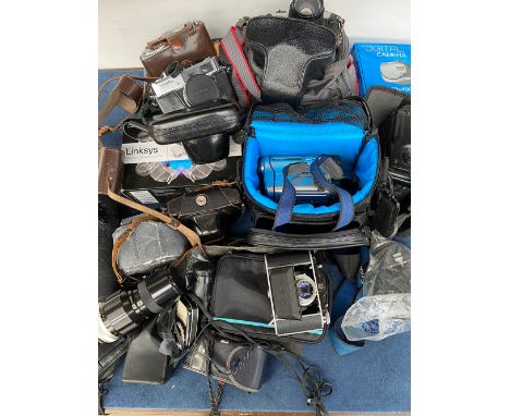 A quantity of vintage cameras and equipment to include: Solida, Minolta, Petri, Nikkormat, Sony Handicam, Fujica, Nikon Nikko