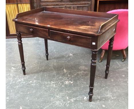 A Regency mahogany three quarter gallery writing table, with two frieze drawers, on lotus and ring turned legs, 103x57x74cmH 