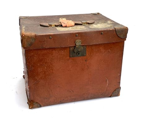 An early 20th century Army &amp; Navy Makers Westminster red travel trunk with leather bracing and handle, bears travel label