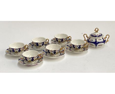 A set of six Limoges porcelain teacups and saucers with sucrier 