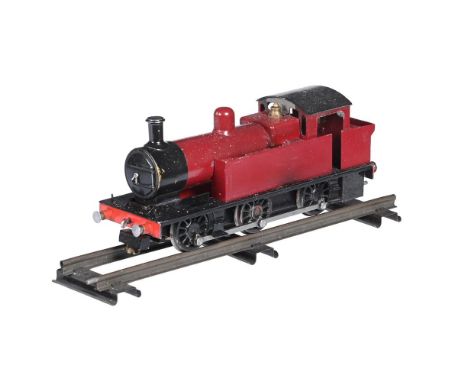 A hand built OO gauge model of a live steam 0-6-0 side tank locomotive, spirit fired and finished in red and black livery, on