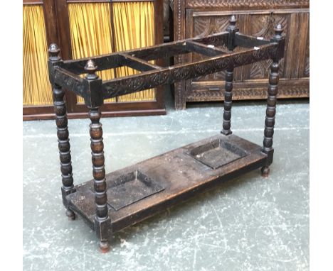 An oak stick stand, with ring and bobbin turning, with two drip trays, 91x30x71cmH 