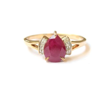 A 9ct gold ring set with a pear shaped ruby flanked by diamonds, the Burmese ruby 1.9cts, size P 1/2, 2.5g 