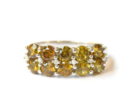 A 10ct white gold ring set with Apache Demantoid garnets and diamonds, the garnets totalling 2cts, size L 1/2, 3.4g 
