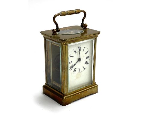 A brass carriage clock, enamel dial with Roman numerals, approx. 10.5cmH 