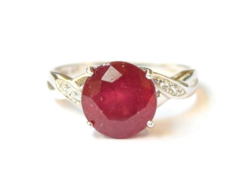 A 9ct white gold ring set with a ruby and white zircons, the Madagascan ruby 5.6cts, size S, 3.4g 