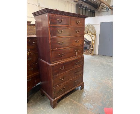 A George III mahogany chest on chest, the top with dentil cornice, over two short and three long drawers, over a base of a fu
