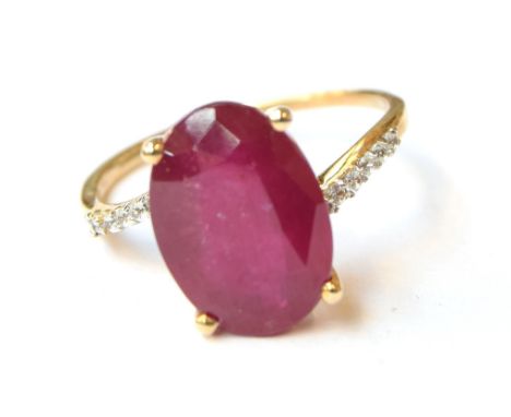 A 9ct gold ring set with a ruby and white zircons, the Madagascan ruby 8.4cts and 14x10mm, size R 1/2, 3.7g 