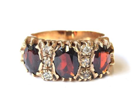 A substantial 9ct gold ring set with garnets and clear stones, size O 1/2, 6.6g
